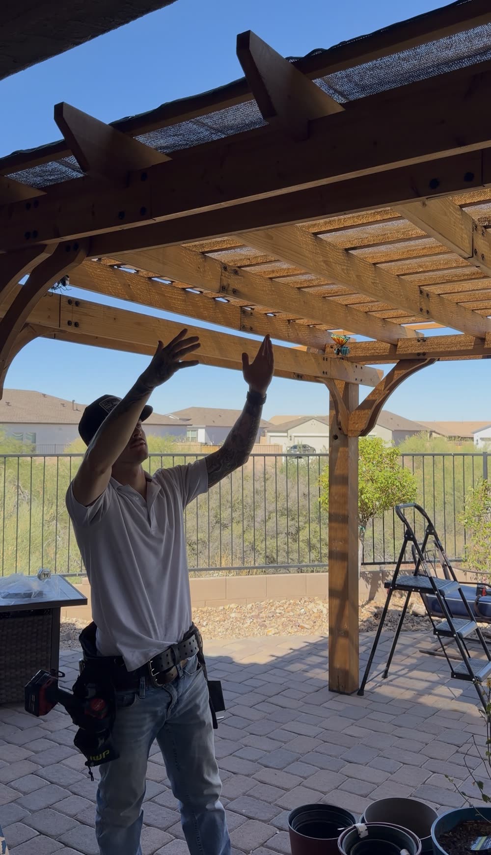 Custom pergola over a paver patio in a Tucson backyard